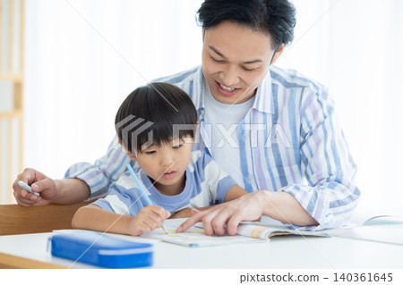 Family: A boy studying with his dad 140361645