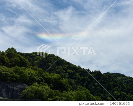 Yagisawa Dam in early summer, with rainbow-colored clouds (iridescent clouds) in the sky, Minakami Town, Gunma Prefecture. 140361665