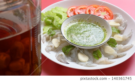 shrimp in fish sauce with Thai spicy seafood dipping sauce on white plate and umeshu 140361745