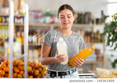 Young woman choosing soda in grocery store Young woman choosing soda in grocery store 140361909