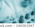 closeup-pipette dropping a sample into a test tube in an experiment research in laboratory. 140361947
