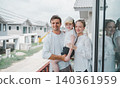 Loving family standing inside new home with warmth and connection 140361959
