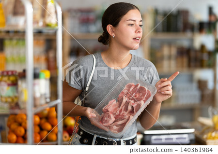 Young woman choosing lamb in grocery store Young woman choosing lamb in grocery store 140361984