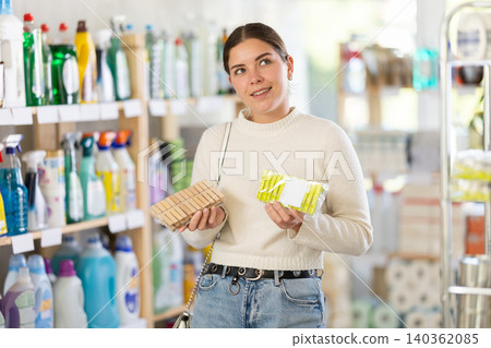 woman chooses clothespins for her home woman chooses clothespins for her home 140362085