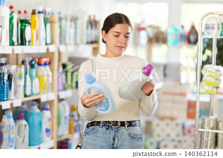 Woman choosing fabric softener Woman choosing fabric softener 140362114