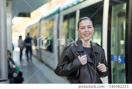 Young woman waiting for tram at public transport stop Young woman waiting for tram at public transport stop 140362221