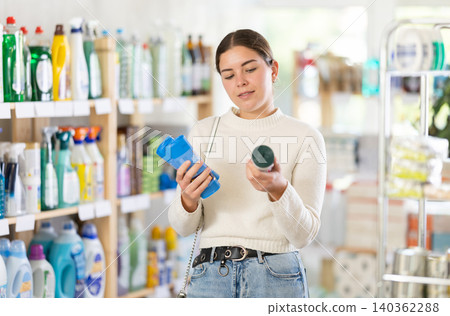 Woman choosing plastic garbage bags Woman choosing plastic garbage bags 140362288