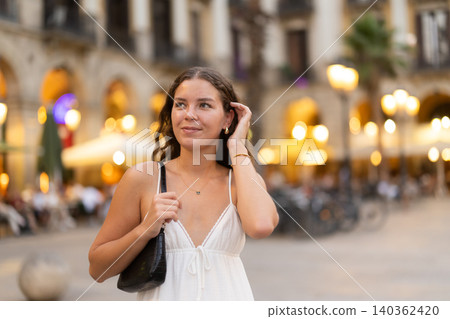 young woman walks through the evening streets of Barcelona young woman walks through the evening streets of Barcelona 140362420