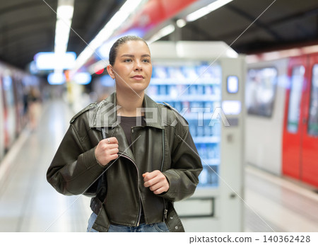 Pretty girl walks along the platform waiting for subway train Pretty girl walks along the platform waiting for subway train 140362428