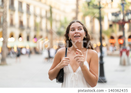 young woman walks through the evening streets of Barcelona young woman walks through the evening streets of Barcelona 140362435