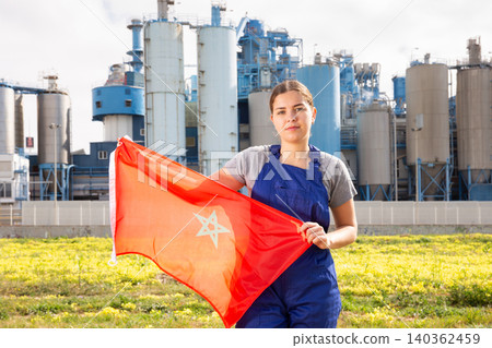 Focused young woman holds the national flag of Morocco Focused young woman holds the national flag of Morocco 140362459