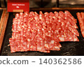 Close up of delicious sliced pork salami cured meat arranged on a dark stone platter at a luxury hotel breakfast buffet. Tasty charcuterie cold cuts for morning brunch catering and food display. 140362586