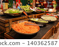 Fresh organic salad bar buffet station in luxury hotel restaurant. Close up of shredded carrots, cucumber and lettuce in metal bowls for healthy vegetarian dining catering and morning brunch. 140362587