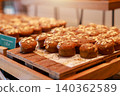 Freshly baked healthy mini banana oat muffins topped with rolled oats on a wooden tray at a luxury hotel breakfast buffet. Delicious sweet bakery dessert pastry for morning brunch food catering. 140362589