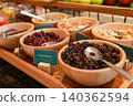 Close up of wooden bowls filled with healthy dried cranberries, dark raisins and mixed nuts at a luxury hotel breakfast buffet station. Sweet organic diet snack for morning catering food display. 140362594