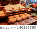 Freshly baked sliced gluten free bread and plain vanilla muffins arranged on rustic wooden trays at a luxury hotel breakfast buffet. Sweet pastry and bakery catering display for morning meal. 140362595