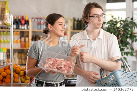man and woman choosing lamb in grocery man and woman choosing lamb in grocery 140362772