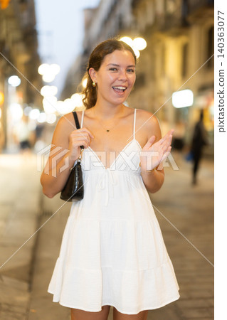 In night, young smiling girl walks along city street Ferran In night, young smiling girl walks along city street Ferran 140363077