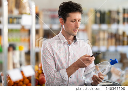 Man scanning soda bottles 140363508