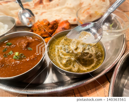 A close-up of spinach curry served at an Indian curry restaurant. Served with naan and tandoori chicken. A close-up of spinach curry served at an Indian curry restaurant. Served with naan and tandoori chicken. 140363561