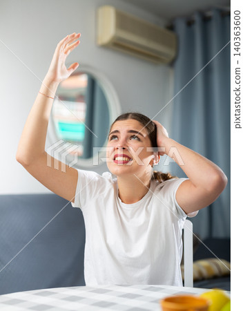 Stressed young woman suffering from noisy neighbors 140363600