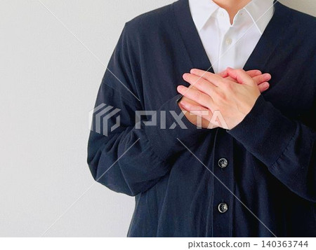 Woman with both hands on her chest Woman with both hands on her chest 140363744