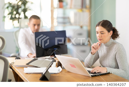 Working in modern office - businesswoman working on laptop Working in modern office - businesswoman working on laptop 140364207