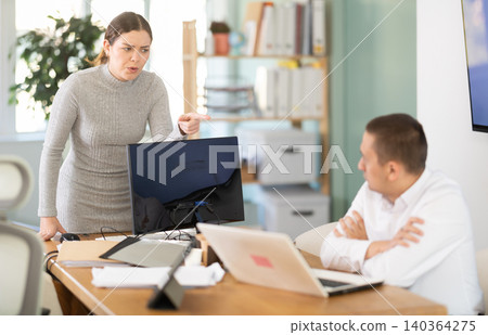 Young woman scolds adult man in office Young woman scolds adult man in office 140364275