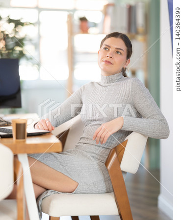 Young woman watching presentation in office Young woman watching presentation in office 140364399