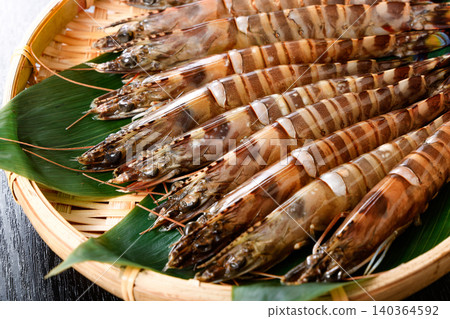 Raw prawns served in a colander Raw prawns served in a colander 140364592