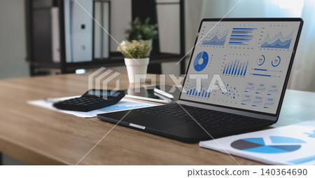 Business dashboard displaying data and graphs on a laptop with financial reports and calculator, supporting performance analysis, reporting workflow, metrics monitoring and business management. Business dashboard displaying data and graphs on a laptop with financial reports and calculator, supporting performance analysis, reporting workflow, metrics monitoring and business management. 140364690
