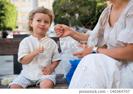Toddler Finishing Healthy Fruit Snack With Caregiver Toddler Finishing Healthy Fruit Snack With Caregiver 140364707