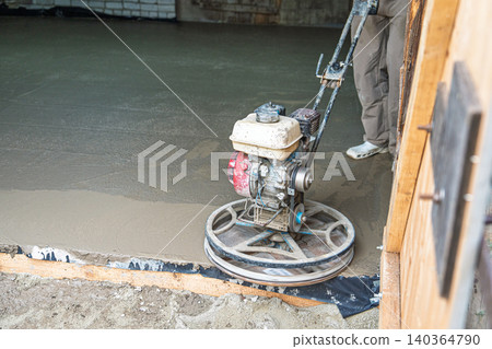 Concrete floor finishing with power trowel machine, construction and home improvement Concrete floor finishing with power trowel machine, construction and home improvement 140364790