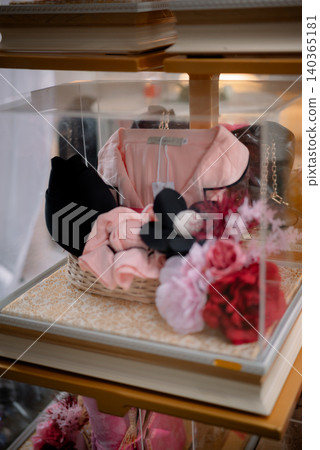 Elegant wedding gift hamper display with fashion accessories and floral arrangements. Elegant wedding gift hamper display with fashion accessories and floral arrangements. 140365181