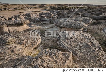 Ancient stone ruins in a vast open landscape under cloudy sky Ancient stone ruins in a vast open landscape under cloudy sky 140365617