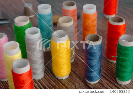 Colorful Sewing Thread Spools On Wooden Table 140365853