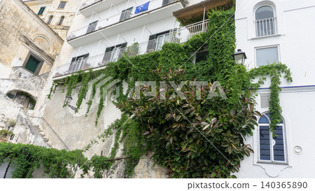 Facades of famous town of Amalfi, located on the Amalfi Coast, with its azure sea and beautiful colorful cliffside houses. Facades of famous town of Amalfi, located on the Amalfi Coast, with its azure sea and beautiful colorful cliffside houses. 140365890