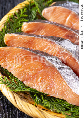 A fresh seafood platter featuring salmon fillets arranged on a bamboo sieve lined with cypress wood. A fresh seafood platter featuring salmon fillets arranged on a bamboo sieve lined with cypress wood. 140365950
