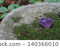 Crystal placed on a stone 140366010