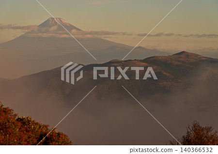 Izu Peninsula, Izu Mountain Ridge Trail, Sunrise over Mt. Fuji and Mt. Daruma as seen from the summit of Mt. Tamashinoyama. Izu Peninsula, Izu Mountain Ridge Trail, Sunrise over Mt. Fuji and Mt. Daruma as seen from the summit of Mt. Tamashinoyama. 140366532