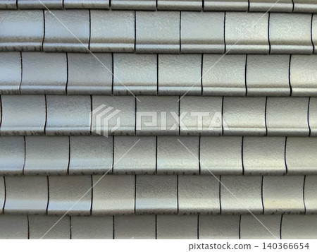 A wall of traditional Japanese roof tiles, beautifully and neatly arranged. A wall of traditional Japanese roof tiles, beautifully and neatly arranged. 140366654