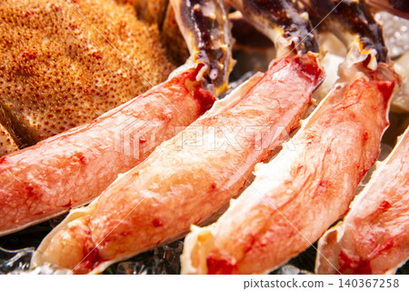 A seafood dish featuring king crab shells and legs lavishly arranged on a sieve lined with ice and cypress wood. A seafood dish featuring king crab shells and legs lavishly arranged on a sieve lined with ice and cypress wood. 140367258