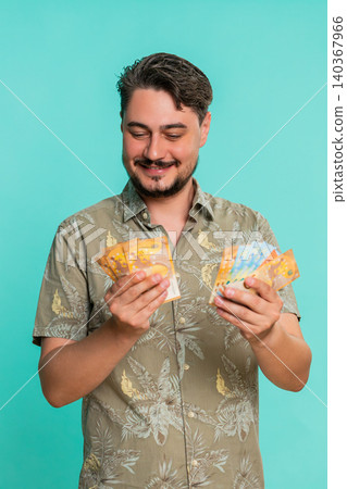 Man counting cash euro money with satisfied smile expressing financial gain recent income savings Man counting cash euro money with satisfied smile expressing financial gain recent income savings 140367966