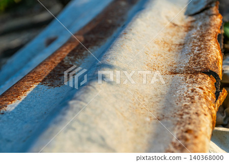 Closeup of weathered corrugated metal sheet rust patterns aged surface texture showing industrial decay material wear outdoor exposure Closeup of weathered corrugated metal sheet rust patterns aged surface texture showing industrial decay material wear outdoor exposure 140368000