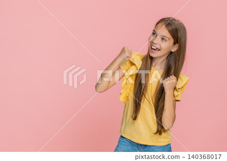 Child girl kid showing victory win gesture while happily and joyfully celebrating success with smile Child girl kid showing victory win gesture while happily and joyfully celebrating success with smile 140368017