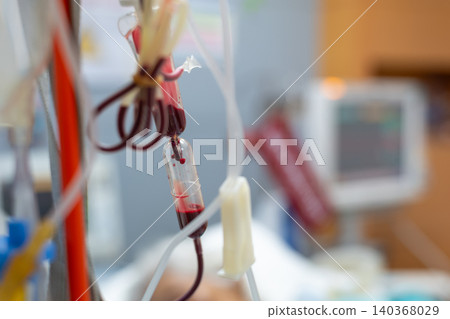 Closeup of blood transfusion tubing flowing blood hospital setting highlighting medical treatment patient care healthcare technology Closeup of blood transfusion tubing flowing blood hospital setting highlighting medical treatment patient care healthcare technology 140368029