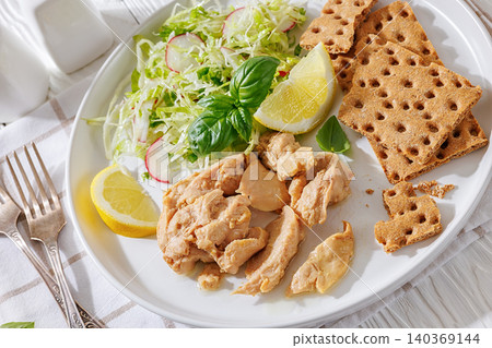 Cod liver with fresh salad, lemon, crispbreads Cod liver with fresh salad, lemon, crispbreads 140369144
