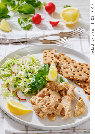Cod liver with fresh salad, lemon, crispbreads Cod liver with fresh salad, lemon, crispbreads 140369149
