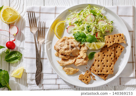 Cod liver with fresh salad, lemon, crispbreads 140369153