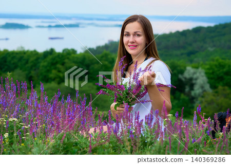 River.Young woman picking bouquet of medic herbs. Sage flowers,greenery River.Young woman picking bouquet of medic herbs. Sage flowers,greenery 140369286